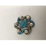 A fine turquoise and diamond brooch of floral desi