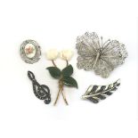 A collection of five brooches including a silver a