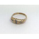An Edwardian 18ct diamond and sapphire ring, (P),