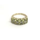 A 9carat gold ring set with green peridot and chip