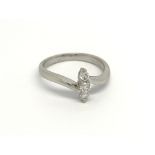 An 18 carat white gold ring set with a vertical ro