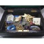 A small leather box of costume jewellery.