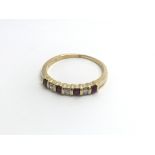 An 18carat gold ring set with an alternating row o