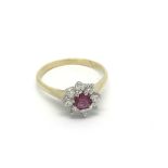 An 18carat gold ruby and diamond cluster ring size k.