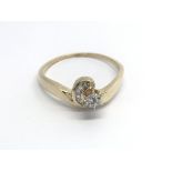 A 9carat gold ring set with a pattern of brilliant