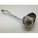 A silver sugar sifter by Cooper & Son in the form