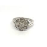 A decorative silver ring set with a pattern of sma