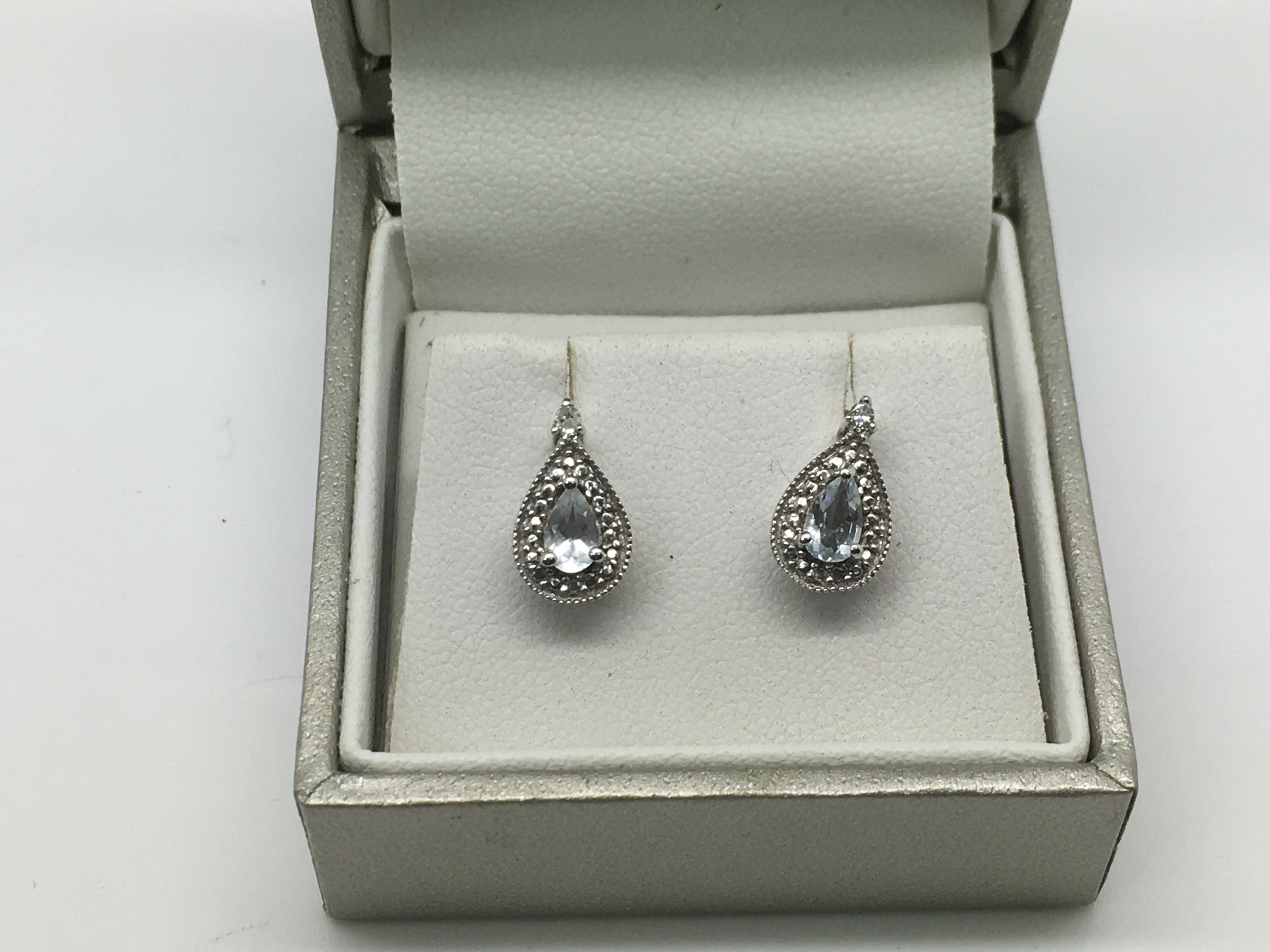 A pair of 9ct white gold drop earrings set diamond