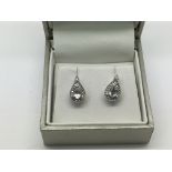 A pair of 9ct white gold drop earrings set diamond
