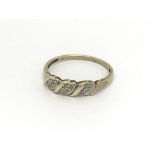 A 9carat gold ring inset with a pattern of diamond