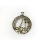 A vintage silver and 9ct gold golfing prize pendan