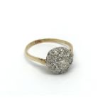 An 18carat gold ring set with a cluster of diamond