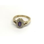 An18carat gold ring set with an oval amethyst flan