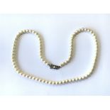 A vintage Mikimoto pearl necklace having silver cl