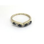 A 9carat gold ring set with four sapphires and dia