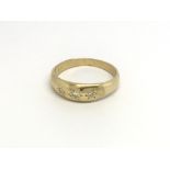 An 18carat Vintage gold ring set with three brilliant cut diamonds. ring size P