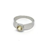 A 9carat white gold ring set with a yellow sapphir