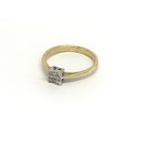 An 18 carat gold ring set with a square pattern of