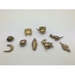 A collection of gold charms, approx 7g.