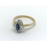 An 18carat gold ring set with a central marquise c