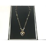 A necklace with 9ct and crystal chain and heart pe