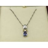 A 14ct White gold diamond and tanzanite pendant on