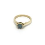 An 18ct gold ring set with a tinted blue diamond,