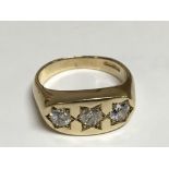A 9carat gold three stone gypsy ring set with thre