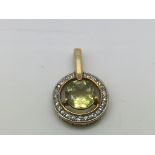 A 9ct gold pendant set with a central citrine in a