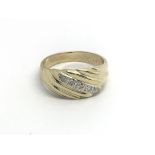 A 9carat gold ring set with a row of brilliant cut