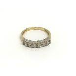 An 18carat gold ring set with a row of alternating