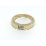 An 18ct gold ring set with four princess cut diamo