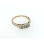 An 18ct gold three stone diamond ring, approx .15c