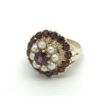 A large garnet or red stone ring set with pearls w