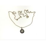 A silver necklace set with black and white natural