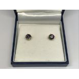 A pair of Rocks & Co 9ct gold earrings set with my
