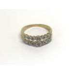 A 9carat gold ring set with two open rows of diamo