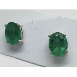 A pair of emerald studs in silver