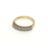 An 18carat gold ring set with a row of diamonds ri