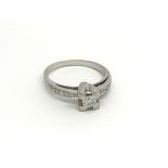 An 18carat white gold ring set with a brilliant cu