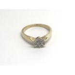 A 9carat gold ring set with a pattern of diamonds