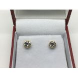A pair of 18ct gold diamond stud earrings, approx