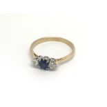 A 18 carat gold ring set with a blue sapphire flan