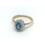 An 18ct gold diamond and topaz ring, (M), 3.2g.