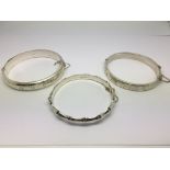 Three silver bracelets.