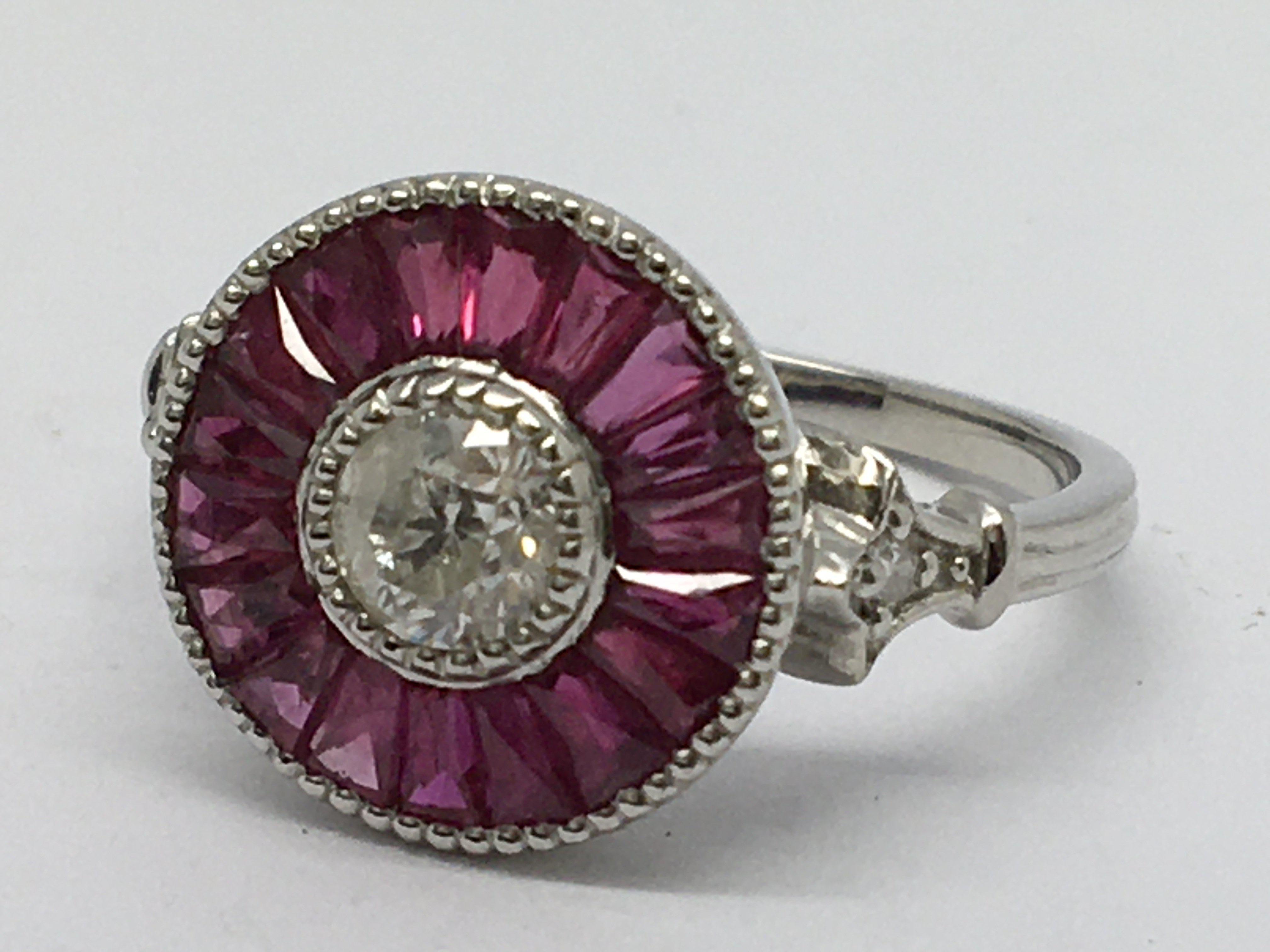 A platinum ruby and diamond target style ring, set