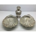 A pair of silver dishes in the form of shells, She