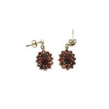 A pair of 9ct gold and garnet earrings, approx 1.8
