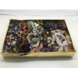 A box of polished gem stone bracelets.