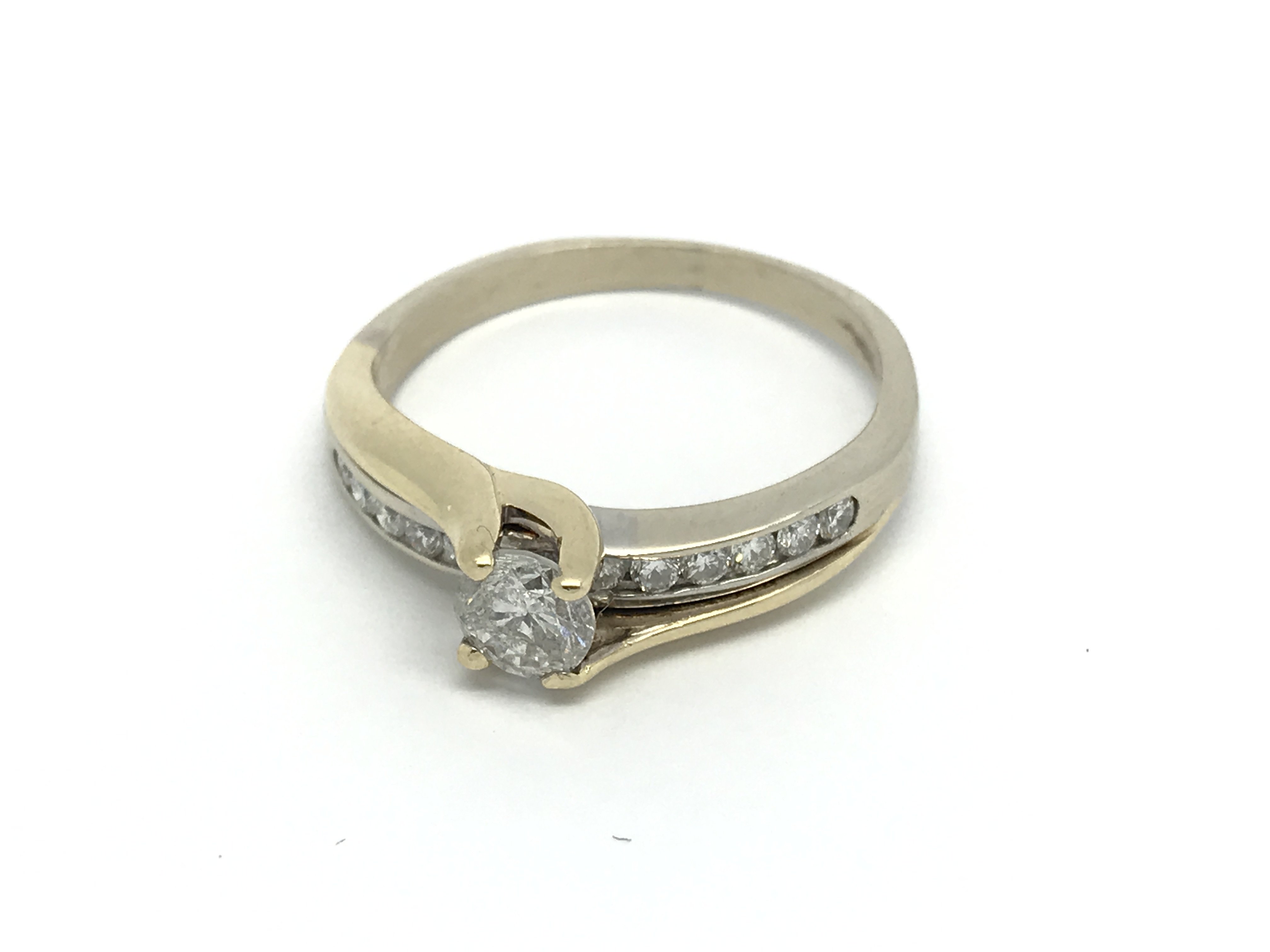 A 14 carat gold ring set with a brilliant cut soli